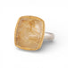 Gold and silver ring with a rutilated quartz stone on a white background