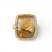 Gold and silver ring with a rutilated quartz stone on a white background