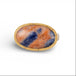 Gold and silver ring with an oval sodalite stone on a white background