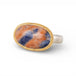 Gold and silver ring with an oval sodalite stone on a white background