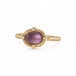 Gold ring with a spinel gemstone on a white background