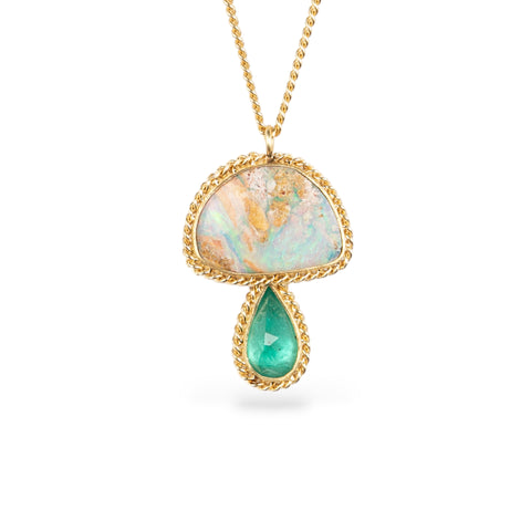 Gold necklace with a mushroom pendant featuring opal and emerald stones on a white background