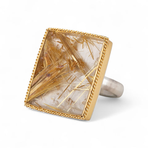 Handcrafted ring made with a rutilated quartz, 18k gold bezel and sterling silver band