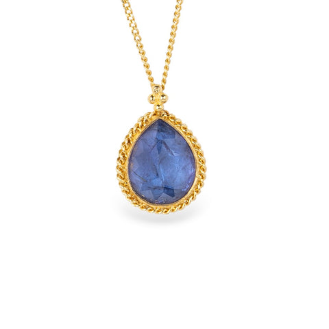 Gold necklace with a blue teardrop tanzanite on a white background