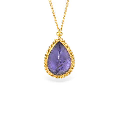 Gold necklace with a tanzanite teardrop pendant on a white background