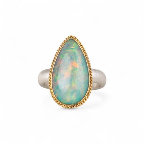 Ethiopian opal teardrop ring with gold bezel and silver band