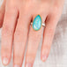 Hand wearing an Ethiopian opal ring with 18k gold bezel and sterling silver band