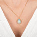 Ethiopian Opal teardrop pendant necklace on a person wearing a white top.