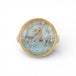 Silver and gold ring with topaz stone on a white background