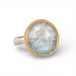 Silver and gold ring with topaz stone on a hand