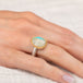 Gold and silver ring with a turquoise stone on a hand
