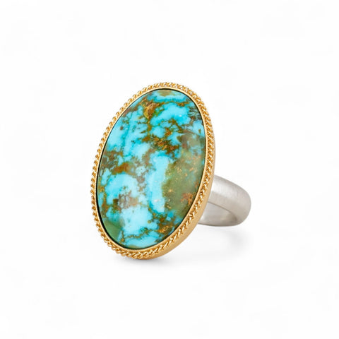 Handmade turquosie ring with a gold bezel and sterling silver band