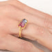 Gold ring with a watermelon tourmaline gemstone on a hand
