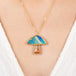 Mushroom necklace with a colorful pendant on a person wearing a white top
