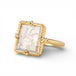 Gold ring with a dendritic quartz stone featuring natural inclusions on a white background