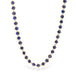Gold chain necklace with lapis gemstones on a white background