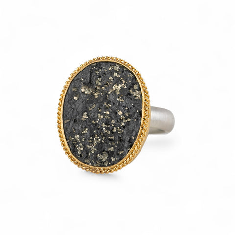 Gold and silver ring with slate with pyrite stone on a white background