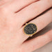 Gold and silver ring with slate with pyrite stone on a hand