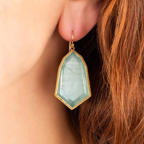Large Aquamarine bell earrings on a model