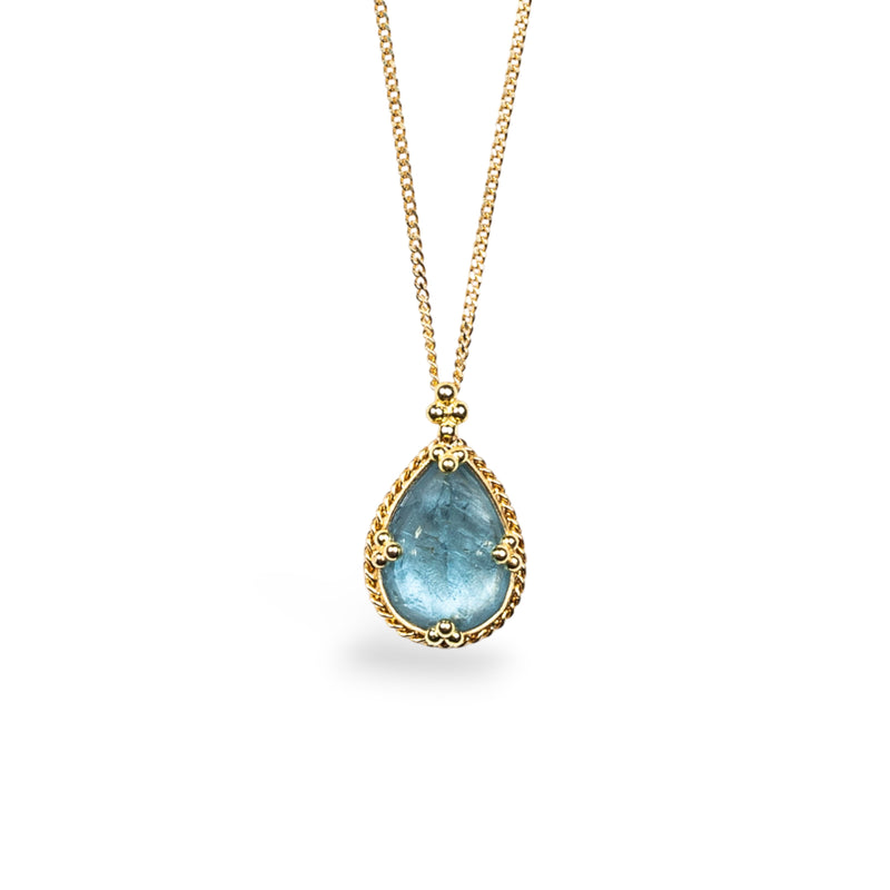 A teardrop shaped aquamarine stone is set in an 18k yellow gold bezel with braided details and granulated prongs. The pendant hangs on a thin gold chain.
