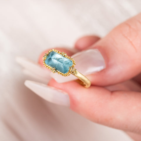 Aquamarine ring held in hand