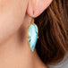 blue opal petrified wood earrings on model