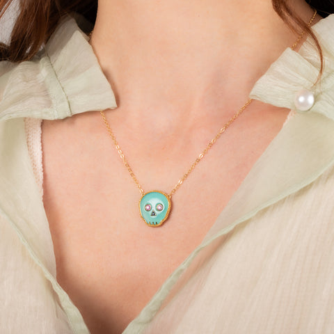 Blue opal skull necklace on model side view