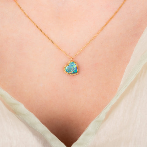 Boudler opal heart necklace on a model