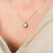 Boulder opal heart necklace on model side view