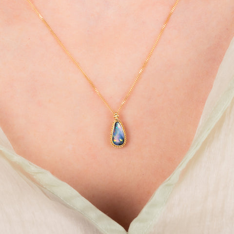 Petite boulder opal necklace on a model