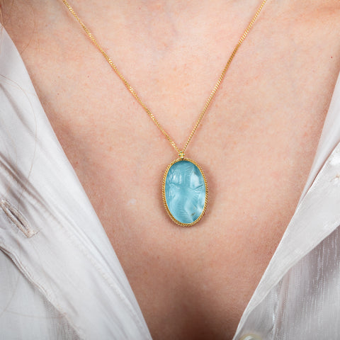 Carved Aquamarine bird necklace on model