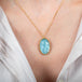 Carved Aquamarine bird necklace on model