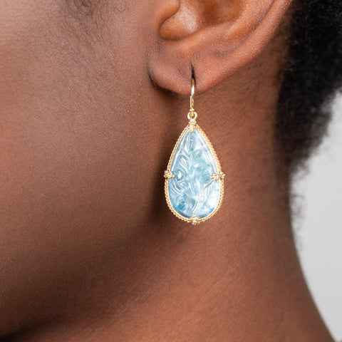 Carved aquamarine earrings on model