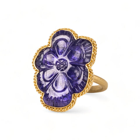 Carved tanzanite flower ring on white background