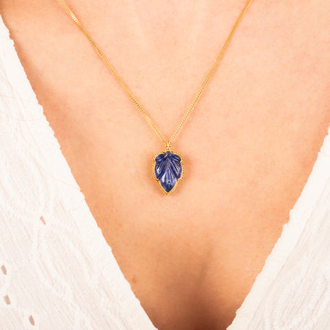 Carved tanzanite leaf necklace on a model