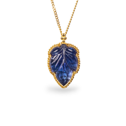 Carved tanzanite leaf necklace on white background