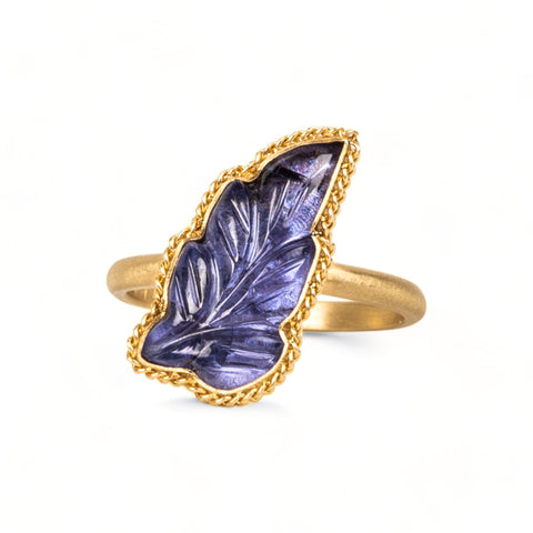 Carved tanzanite leaf ring on white background