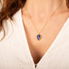 Carved tanzanite leaf necklace on model side view