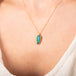 Carved ethiopian opal necklace on model side view