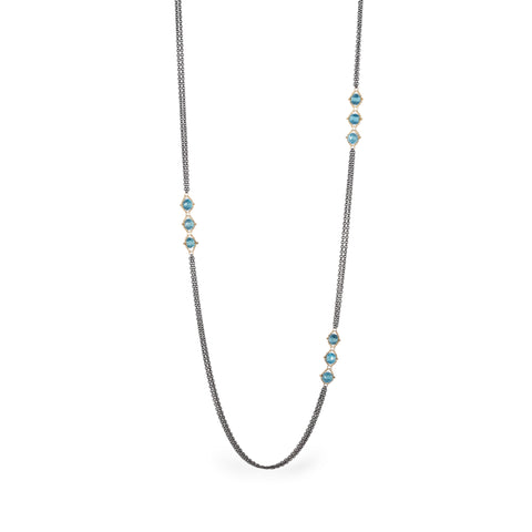 Oxidized silver and gold necklace with london blue topaz on white background