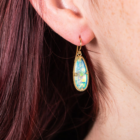 Crystal opal earrings on model