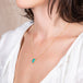 Carved Ethiopian Opal leaf necklace on a model side view