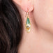 Blue opal petrified wood earrings on a model