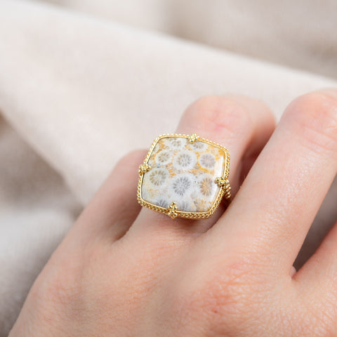 Rectangular fossilized coral ring on a model