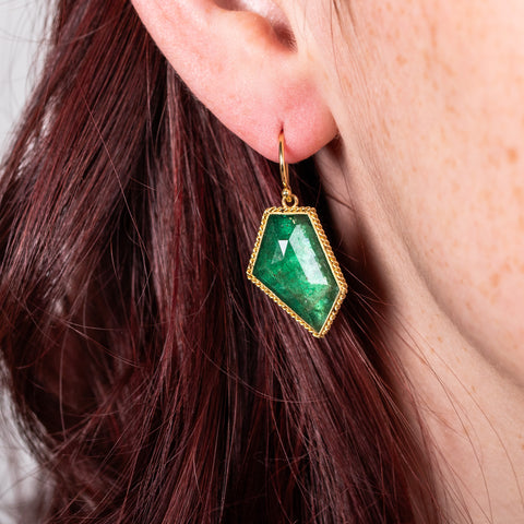 Geometric emerald earrings on model