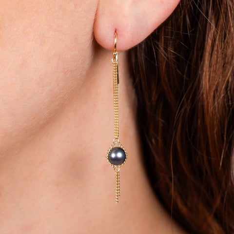 Grey akoya pearl earrings on model