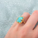 Boulder opal ring on a model