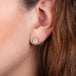 White Topaz stud earrings on a model.