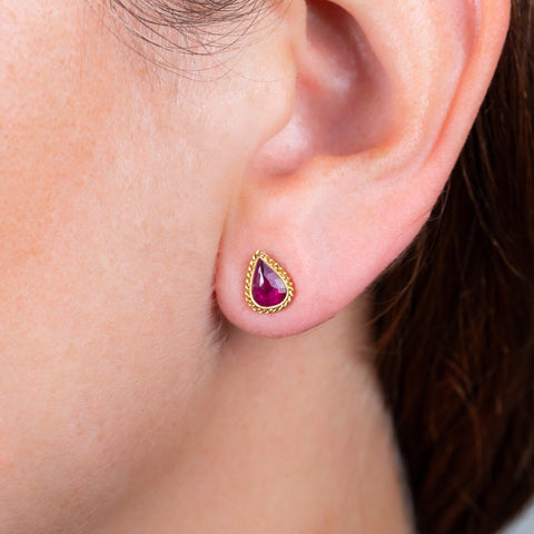 Ruby teardrop earrings on model.