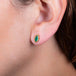 Emerald stud earrings on a model